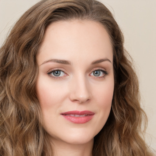 Joyful white young-adult female with long  brown hair and green eyes