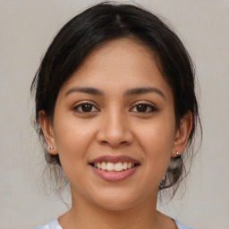 Joyful latino young-adult female with medium  brown hair and brown eyes