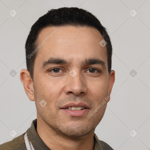 Joyful white young-adult male with short  black hair and brown eyes