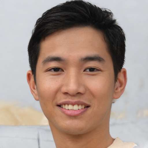 Joyful asian young-adult male with short  brown hair and brown eyes