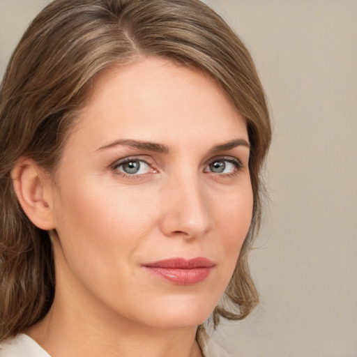 Joyful white young-adult female with medium  brown hair and blue eyes