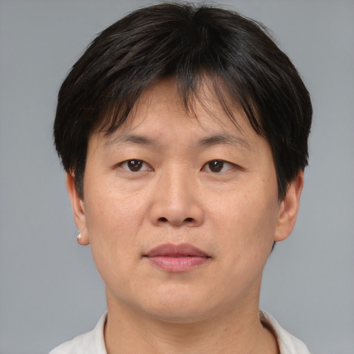 Joyful asian adult female with short  brown hair and brown eyes