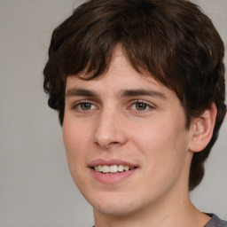 Joyful white young-adult male with medium  brown hair and brown eyes