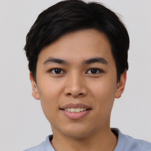 Joyful asian young-adult male with short  black hair and brown eyes
