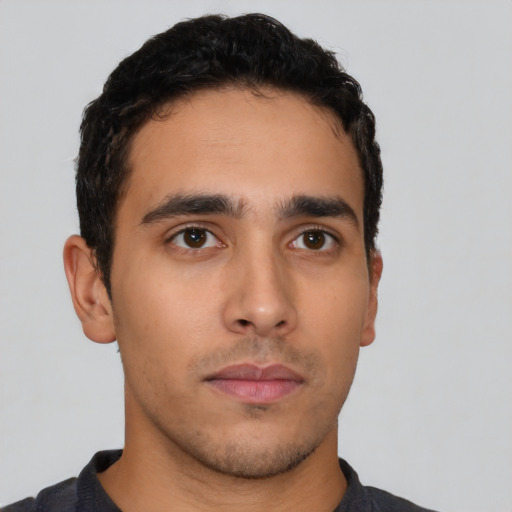 Neutral latino young-adult male with short  black hair and brown eyes