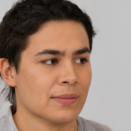 Joyful latino young-adult male with short  brown hair and brown eyes