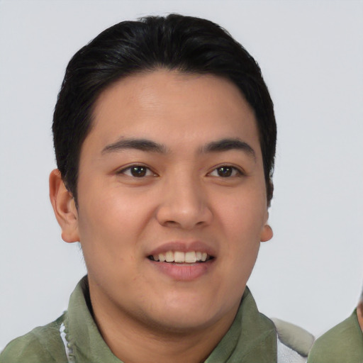 Joyful asian young-adult male with short  black hair and brown eyes