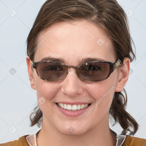 Joyful white young-adult female with medium  brown hair and blue eyes