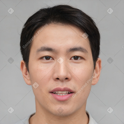 Joyful asian young-adult male with short  brown hair and brown eyes