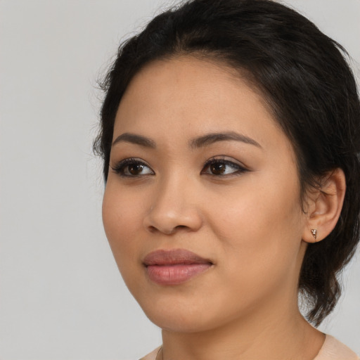 Joyful latino young-adult female with medium  black hair and brown eyes