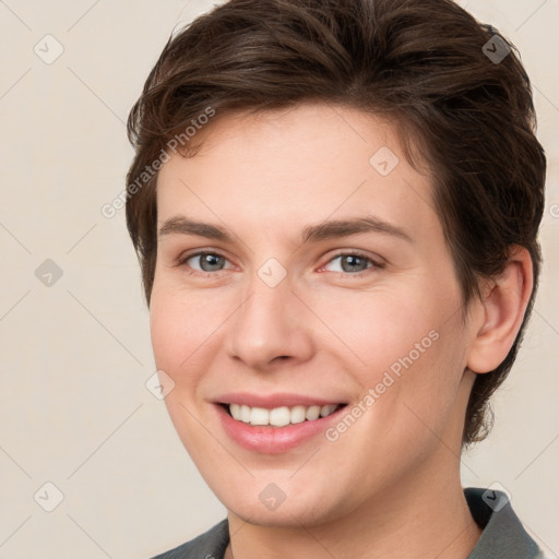 Joyful white young-adult female with medium  brown hair and grey eyes