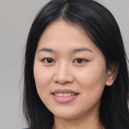 Joyful asian young-adult female with long  black hair and brown eyes