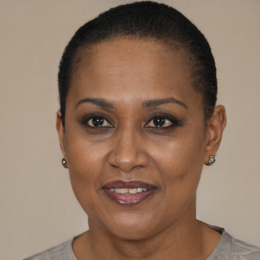 Joyful black adult female with short  brown hair and brown eyes