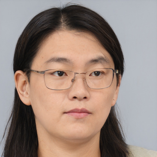 Neutral asian adult female with long  brown hair and brown eyes