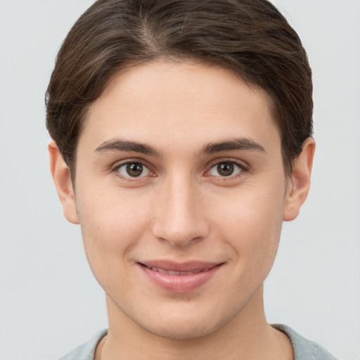 Joyful white young-adult female with short  brown hair and brown eyes