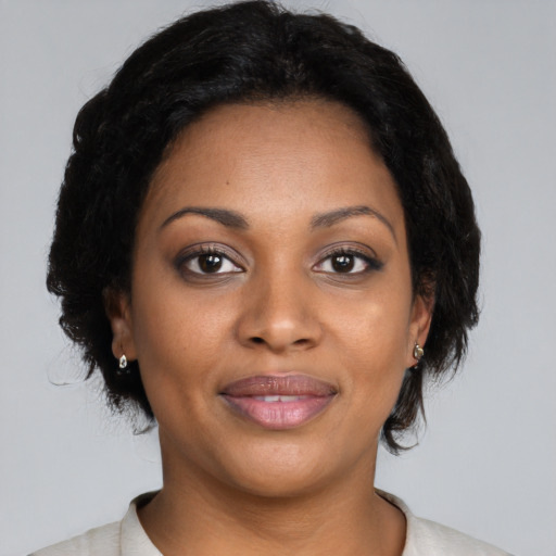 Joyful black young-adult female with medium  black hair and brown eyes