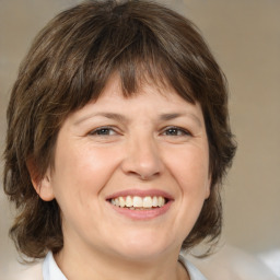 Joyful white adult female with medium  brown hair and brown eyes