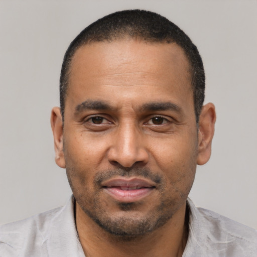 Joyful latino adult male with short  black hair and brown eyes