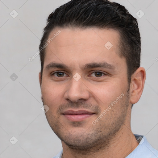 Joyful white young-adult male with short  black hair and brown eyes