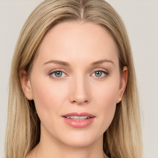 Joyful white young-adult female with long  brown hair and blue eyes