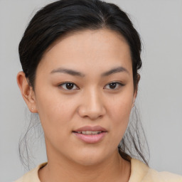 Joyful asian young-adult female with medium  brown hair and brown eyes