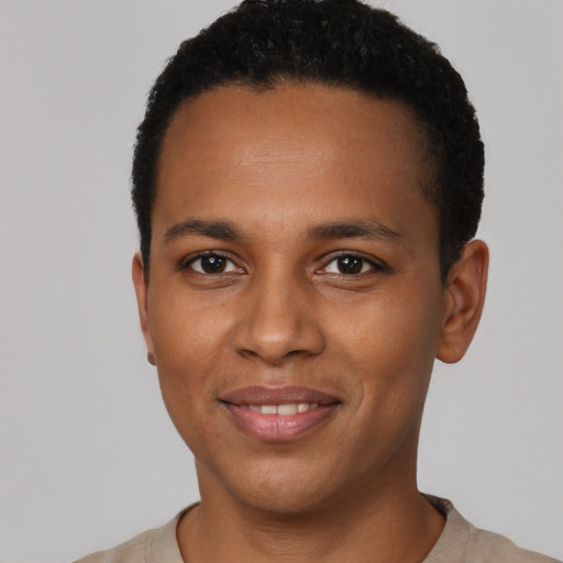Joyful black young-adult male with short  black hair and brown eyes