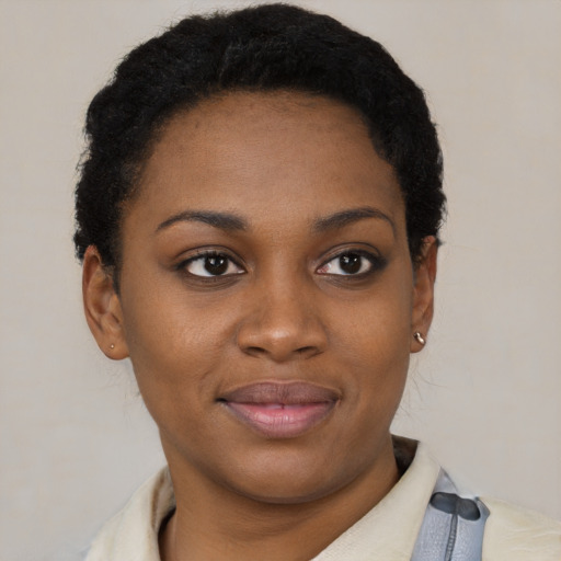 Joyful black young-adult female with short  black hair and brown eyes