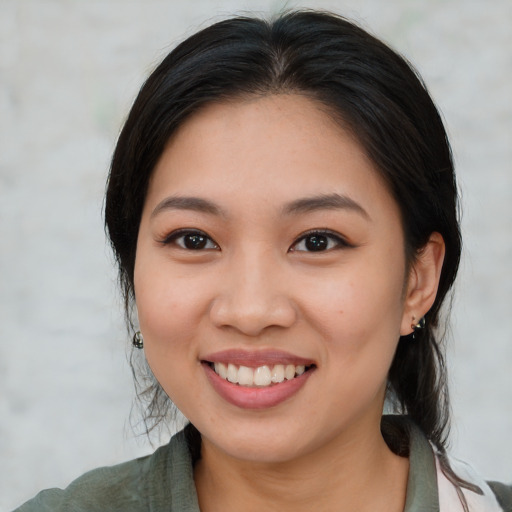 Joyful asian young-adult female with medium  brown hair and brown eyes