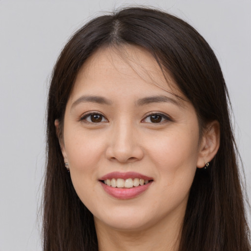 Joyful white young-adult female with long  brown hair and brown eyes