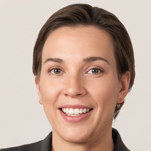 Joyful white young-adult female with short  brown hair and grey eyes