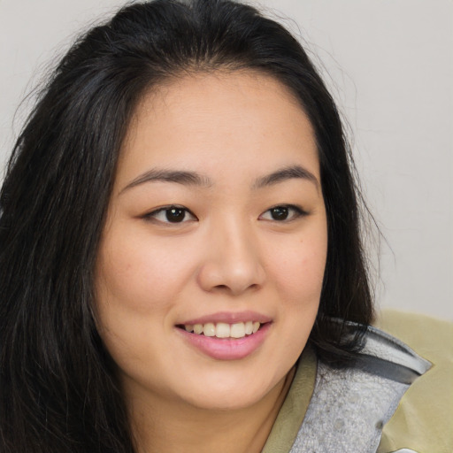 Joyful asian young-adult female with long  brown hair and brown eyes