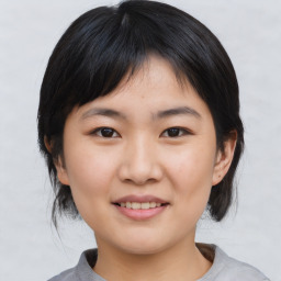 Joyful asian young-adult female with medium  black hair and brown eyes