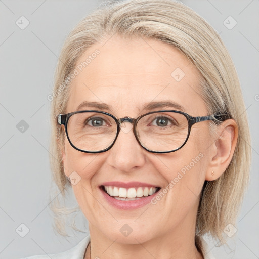 Joyful white adult female with medium  brown hair and blue eyes