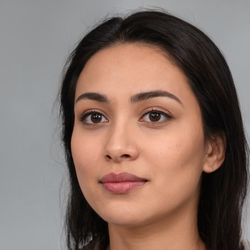 Joyful white young-adult female with long  black hair and brown eyes