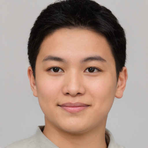 Joyful asian young-adult male with short  black hair and brown eyes