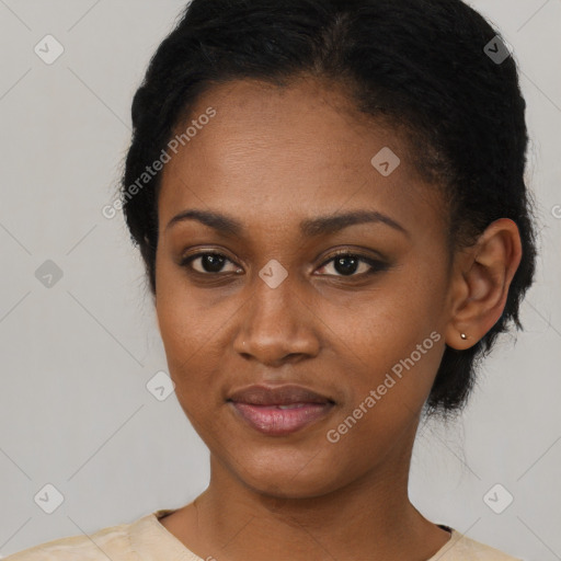 Joyful black young-adult female with short  black hair and brown eyes