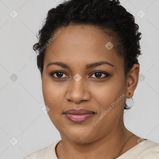 Joyful black young-adult female with short  black hair and brown eyes