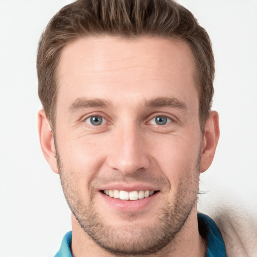 Joyful white young-adult male with short  brown hair and grey eyes