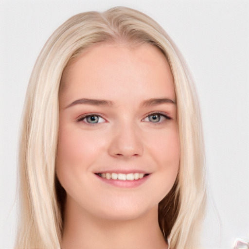 Joyful white young-adult female with long  brown hair and blue eyes