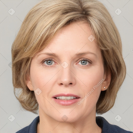 Joyful white adult female with medium  brown hair and blue eyes