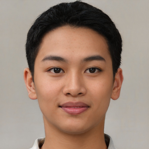Joyful asian young-adult male with short  black hair and brown eyes