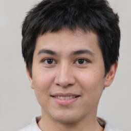 Joyful asian young-adult male with short  brown hair and brown eyes