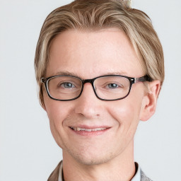 Joyful white adult male with short  brown hair and blue eyes