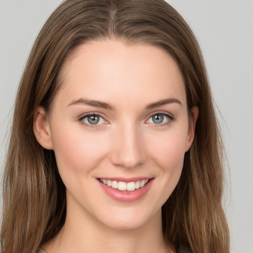 Joyful white young-adult female with long  brown hair and grey eyes