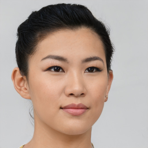 Joyful asian young-adult female with short  brown hair and brown eyes