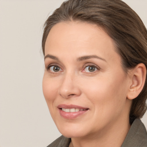 Joyful white adult female with medium  brown hair and brown eyes