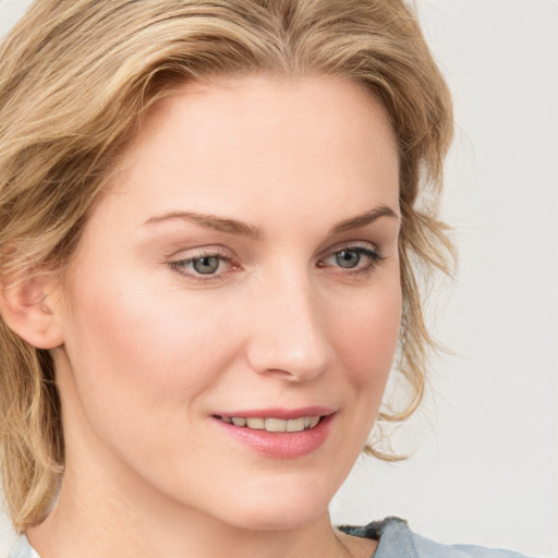 Joyful white young-adult female with medium  brown hair and blue eyes