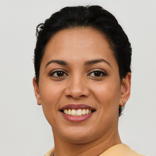 Joyful latino young-adult female with short  brown hair and brown eyes