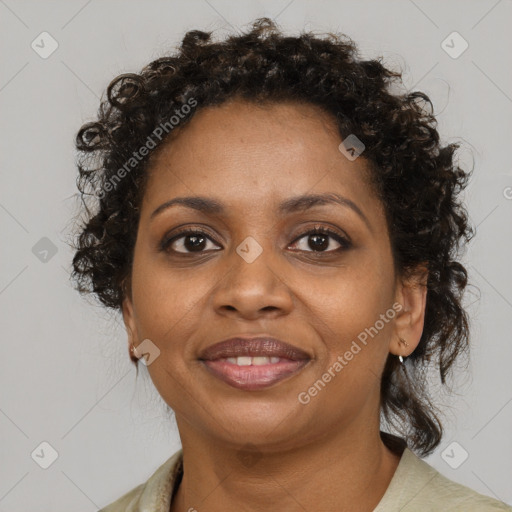 Joyful black adult female with medium  brown hair and brown eyes