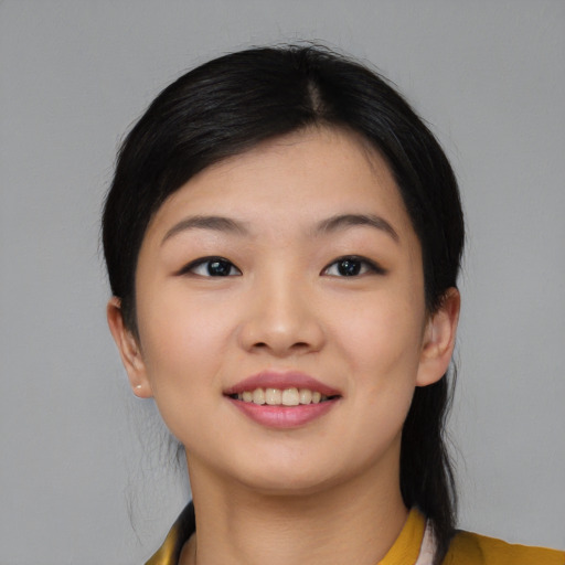 Joyful asian young-adult female with medium  black hair and brown eyes